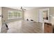 Bright living room with light wood-look flooring, large window, and a view of the backyard at 5420 Stevehaven Ln, Cumming, GA 30028