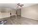 Spacious living room with wood-look flooring, ceiling fan, and neutral tones, creating an inviting atmosphere at 5420 Stevehaven Ln, Cumming, GA 30028