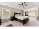 Large main bedroom with a tray ceiling, plush carpet, and ample natural light at 5420 Stevehaven Ln, Cumming, GA 30028