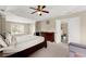 Large main bedroom featuring a large bed, carpet, and natural lighting at 5420 Stevehaven Ln, Cumming, GA 30028