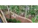 Expansive backyard features natural landscaping, gravel paths and a play area for outdoor enjoyment at 6630 Club Valley Ct, Suwanee, GA 30024