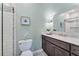 Bathroom featuring a marble countertop, wood cabinets, modern fixtures, and subway tile shower at 6630 Club Valley Ct, Suwanee, GA 30024