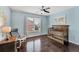Cozy Bedroom with hardwood floors, a comfortable chair and a wooden crib, bathed in natural light at 6630 Club Valley Ct, Suwanee, GA 30024
