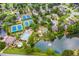 Aerial view of a community with tennis courts, a pool, a playground, and a scenic pond with a fountain at 6630 Club Valley Ct, Suwanee, GA 30024