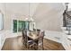Elegant dining room with hardwood floors, a grand chandelier, and large windows at 6630 Club Valley Ct, Suwanee, GA 30024