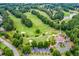 Aerial view of a beautiful golf course community with lush green fairways and mature trees at 6630 Club Valley Ct, Suwanee, GA 30024
