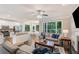 Open-concept living room with hardwood floors and large windows overlooking lush greenery, offering a bright and airy ambiance at 6630 Club Valley Ct, Suwanee, GA 30024
