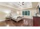 Spacious main bedroom featuring trey ceilings, a large window, and hardwood floors at 6630 Club Valley Ct, Suwanee, GA 30024