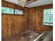 Wood paneled bedroom with two windows ready to be refreshed at 1159 Eastridge Sw Rd, Atlanta, GA 30311
