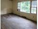 Empty living room featuring hardwood floors, large windows providing natural light, and neutral wall colors at 1159 Eastridge Sw Rd, Atlanta, GA 30311