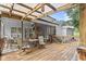 Relaxing screened porch featuring a wooden deck, ceiling fan, cafe table, and outdoor lighting at 1418 Mill Path Loop, Lawrenceville, GA 30045