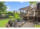 Backyard oasis featuring a koi pond and a deck, enhancing outdoor living and entertaining at 1418 Mill Path Loop, Lawrenceville, GA 30045