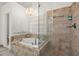 Bathroom with a soaking tub, tiled shower, and chandelier at 1418 Mill Path Loop, Lawrenceville, GA 30045