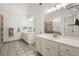 Bright bathroom with double vanity sinks, tile floor, and modern lighting at 1418 Mill Path Loop, Lawrenceville, GA 30045