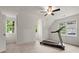 Bright bonus room features a treadmill and large windows. Great for exercising at 1418 Mill Path Loop, Lawrenceville, GA 30045