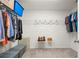 Walk-in closet providing ample storage with shelves and hanging rods at 1418 Mill Path Loop, Lawrenceville, GA 30045
