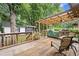 A well-maintained wooden deck features seating and a transparent pergola, perfect for outdoor living at 1418 Mill Path Loop, Lawrenceville, GA 30045