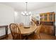 Bright dining room featuring a hardwood floor and a view of the stairs and hallway at 1418 Mill Path Loop, Lawrenceville, GA 30045