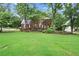 Charming brick two-story home with a well-manicured lawn and mature landscaping at 1418 Mill Path Loop, Lawrenceville, GA 30045