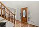 Lovely foyer featuring hardwood floors, a staircase, and a decorative front door at 1418 Mill Path Loop, Lawrenceville, GA 30045
