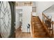 Bright foyer featuring hardwood floors, an elegant front door, and a staircase at 1418 Mill Path Loop, Lawrenceville, GA 30045