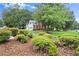 View of the front yard with bushes and trees with the home in the background at 1418 Mill Path Loop, Lawrenceville, GA 30045