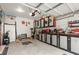 Attached garage featuring a gray floor, an open door, and a well-organized tool display at 1418 Mill Path Loop, Lawrenceville, GA 30045