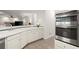 Bright kitchen with double ovens and white cabinets, complemented by a tiled floor at 1418 Mill Path Loop, Lawrenceville, GA 30045