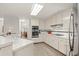 Spacious kitchen with white cabinets, stainless steel appliances, and a tile floor at 1418 Mill Path Loop, Lawrenceville, GA 30045
