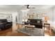 Comfortable living room with hardwood floors, ceiling fan, and access to the kitchen area at 1418 Mill Path Loop, Lawrenceville, GA 30045