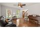 A well-lit living room with a piano, a comfortable sofa, and hardwood floors at 1418 Mill Path Loop, Lawrenceville, GA 30045