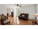 Sunlit living room with wood floors, a leather sofa, and elegant decor at 1418 Mill Path Loop, Lawrenceville, GA 30045