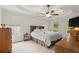 Spacious main bedroom featuring a tray ceiling, ceiling fan, and natural light at 1418 Mill Path Loop, Lawrenceville, GA 30045