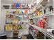 Walk-in pantry with ample storage, fully stocked with food and household goods at 1418 Mill Path Loop, Lawrenceville, GA 30045