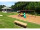 View of a community playground, complete with a slide, swings, and a gazebo, surrounded by green grass at 1418 Mill Path Loop, Lawrenceville, GA 30045
