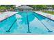Community pool surrounded by sun loungers, tables, and umbrellas for relaxation at 1418 Mill Path Loop, Lawrenceville, GA 30045
