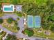 Aerial view showcasing the community pool, tennis courts, parking, and surrounding green space at 1418 Mill Path Loop, Lawrenceville, GA 30045