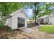 Exterior view of a shed with double doors, providing plenty of space for storage and projects at 1418 Mill Path Loop, Lawrenceville, GA 30045