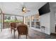 Light-filled screened porch with tiled floor, ceiling fan, and outdoor view at 1418 Mill Path Loop, Lawrenceville, GA 30045