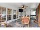 Bright and airy screened porch with tiled floor, ceiling fan, and comfortable seating at 1418 Mill Path Loop, Lawrenceville, GA 30045