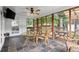 Inviting screened porch with tiled floor, ceiling fan, and view of outdoor deck at 1418 Mill Path Loop, Lawrenceville, GA 30045