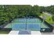 Aerial view of two community tennis courts with green and blue surfaces, surrounded by trees and black fencing at 1418 Mill Path Loop, Lawrenceville, GA 30045