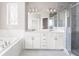 This bathroom features a double sink vanity, large tub, and walk-in shower at 164 Blakemore Dr, Smyrna, GA 30080