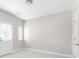 Bright bedroom with neutral carpet, walls, white trim, a door, and a window allowing natural light at 164 Blakemore Dr, Smyrna, GA 30080