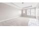 Spacious bedroom with neutral carpeting, ample natural light, and a tray ceiling at 164 Blakemore Dr, Smyrna, GA 30080