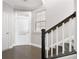 Bright entryway features hardwood floors, white trim and staircase with contrasting railing and stairs at 164 Blakemore Dr, Smyrna, GA 30080