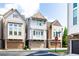 View of townhome with a stone facade, second story balcony, and attached garage at a neighborhood intersection at 164 Blakemore Dr, Smyrna, GA 30080