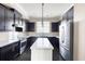 Well-appointed kitchen with stainless steel appliances, dark cabinets, and a center island at 164 Blakemore Dr, Smyrna, GA 30080