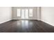 Bright living room with hardwood floors, neutral walls, large glass patio doors, and a modern ambiance at 164 Blakemore Dr, Smyrna, GA 30080