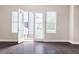 Bright living room featuring patio access and rich, dark hardwood flooring at 164 Blakemore Dr, Smyrna, GA 30080